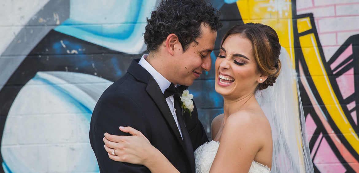 Nieto houston wedding creative couple portrait laugh at graffiti building wall by steve lee photography