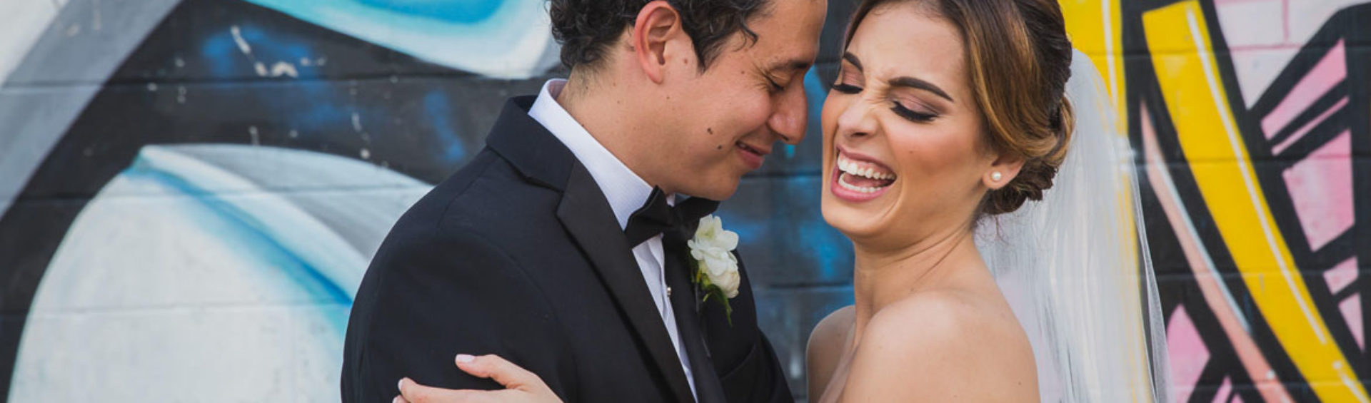 Nieto houston wedding creative couple portrait laugh at graffiti building wall by steve lee photography