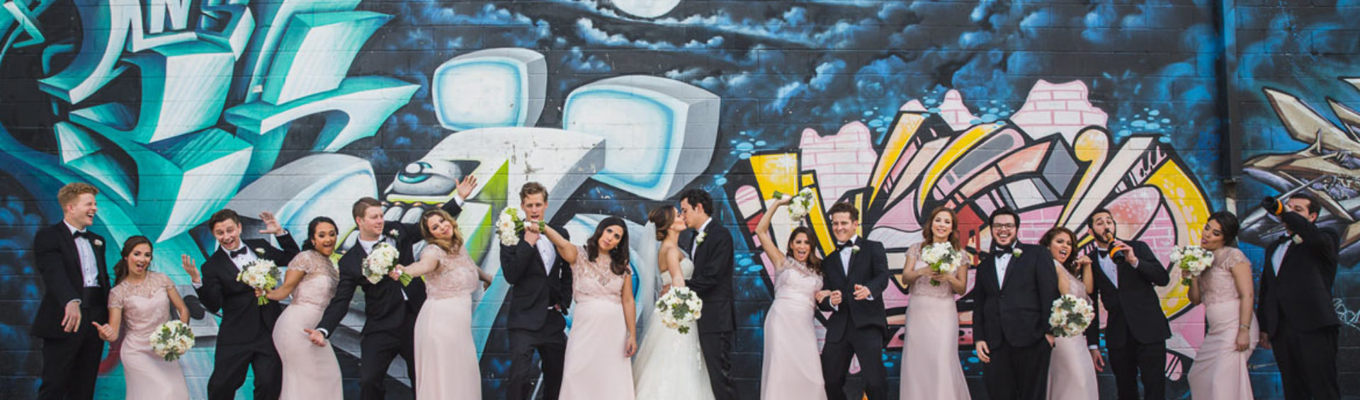 Nieto houston wedding party portrait at graffiti building wall by steve lee photography